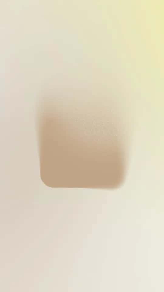A slightly angular object of a darker beige color against a light beige background.