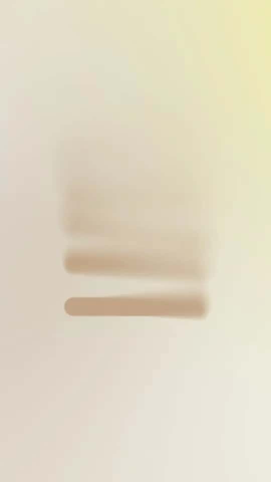 Blurred text with three brown lines on a beige background.