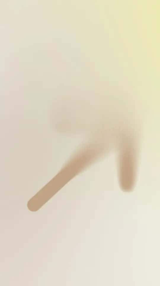 A hand behind frosted glass, with a finger pointing down and to the right.