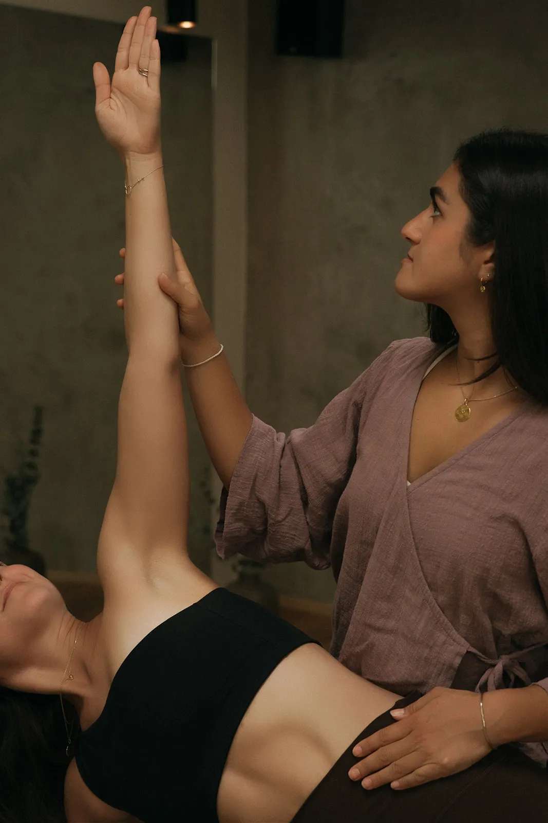 Kimia guides a hands-on yoga practice at Yoga Movement Prague.